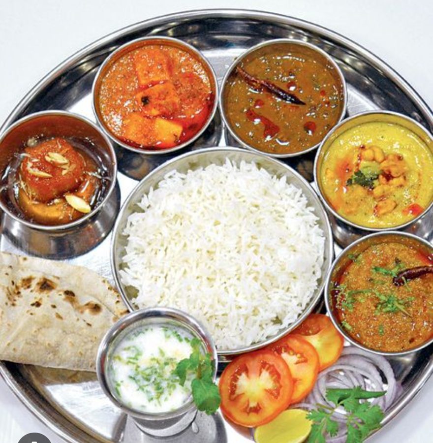 A full Indian thali with rice, roti, curries, curd and salad